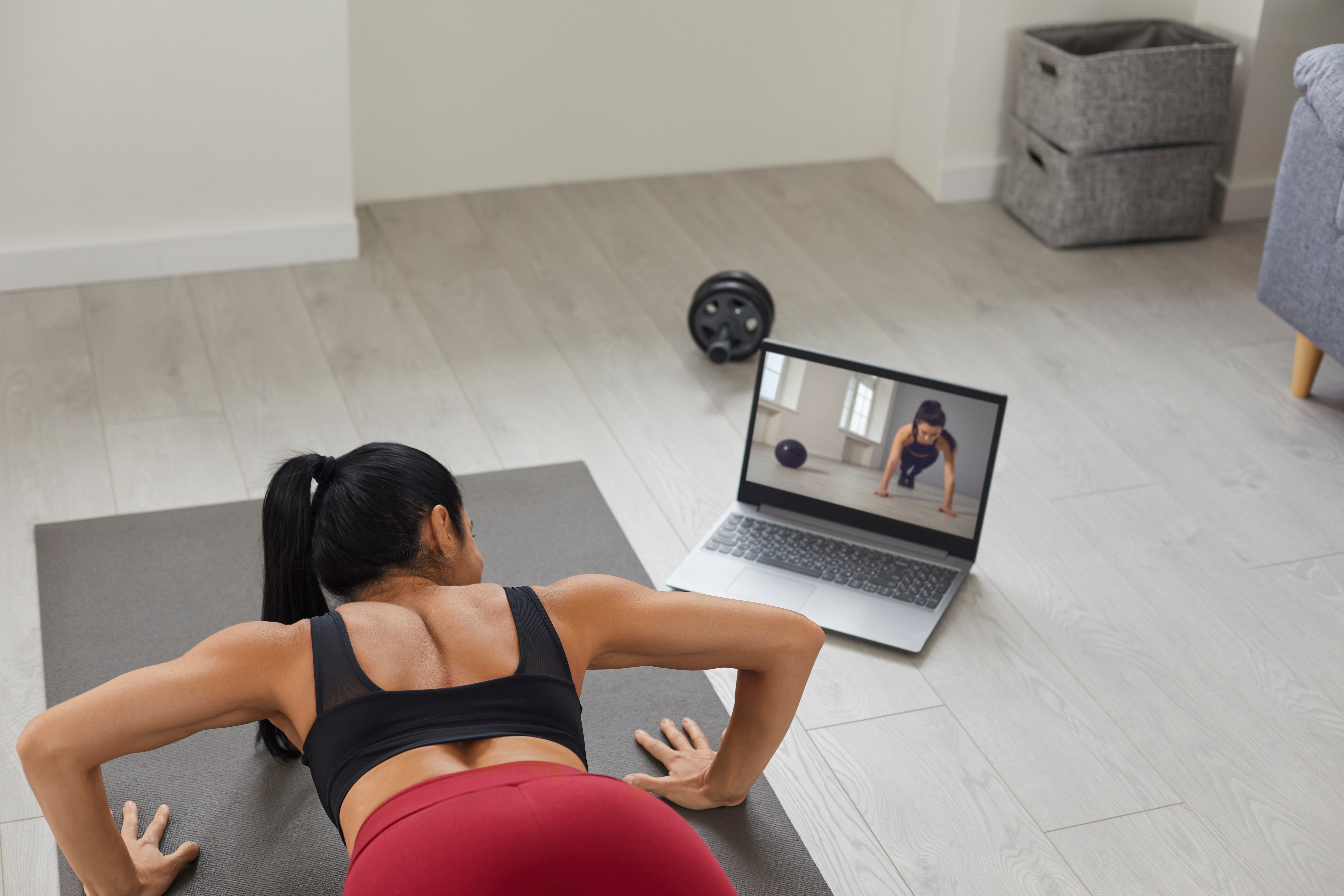 Fit Woman Athlete Doing Online Workout on Mat at Home